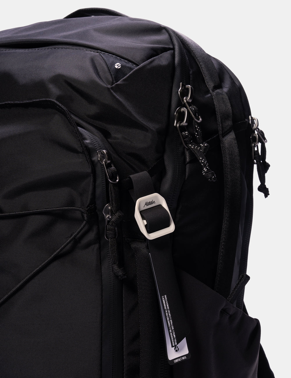 Close-up of a black bag with a strap featuring the Matador logo.