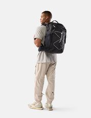 Person wearing a black backpack on a white background