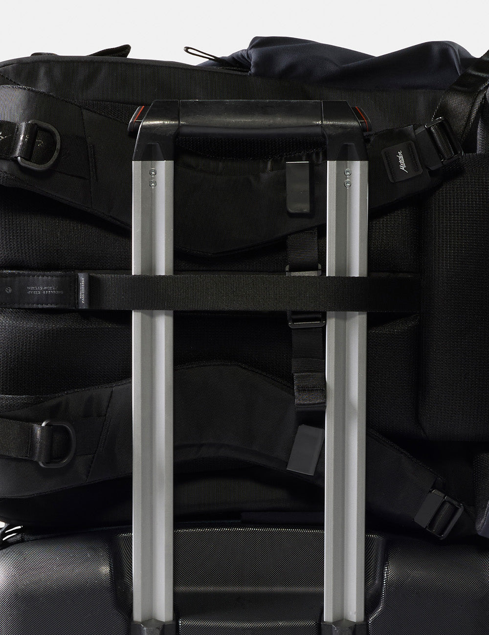 black backpack on luggage handle