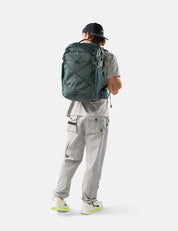 Person wearing a green backpack on a white background