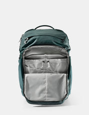 Green backpack with open compartments on a white background