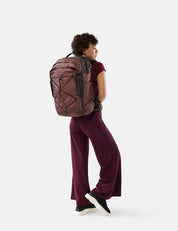 Person wearing a garnet backpack on a white background