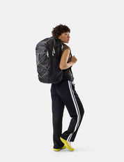 person on white background wearing black bag  with light blue cord and pullers