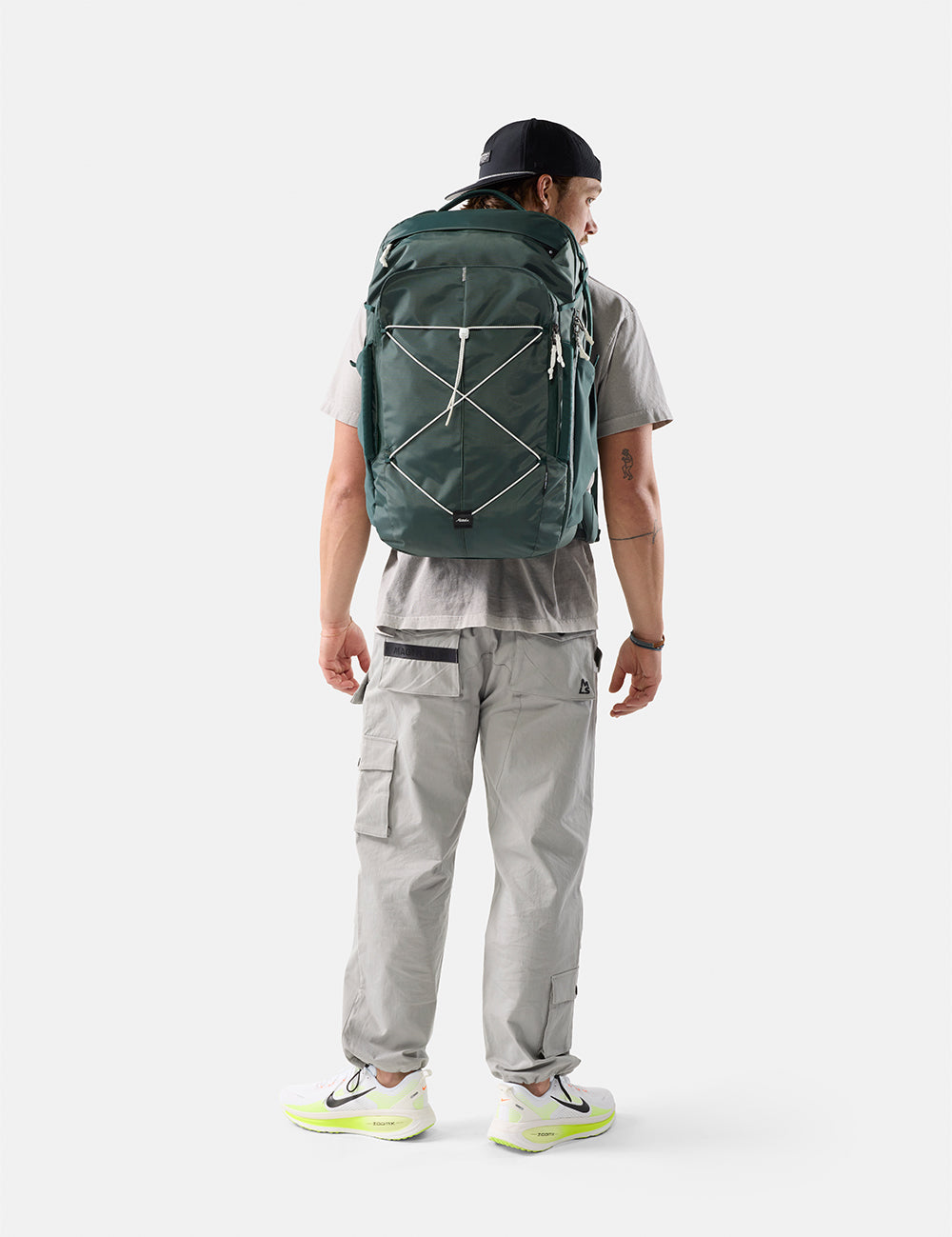 person wearing juniper bag with white cord and pullers on white background