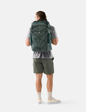 Person wearing a green backpack on a white background