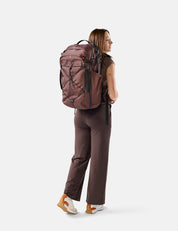 Person wearing a garnet backpack on a white background