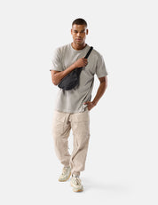 Man holding a black bag against a white background
