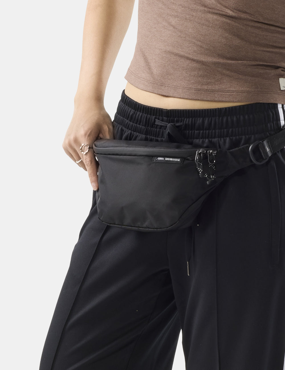 black 2l sling worn at front of person's waist
