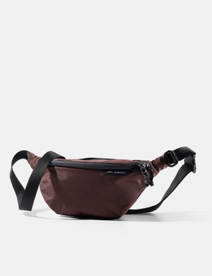 Garnet sling with black strap on a white background
