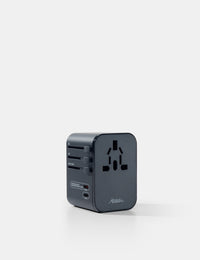 Black travel adapter on a white background