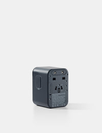 Black travel adapter on a white background