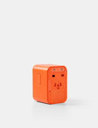 Orange power adapter on a white background