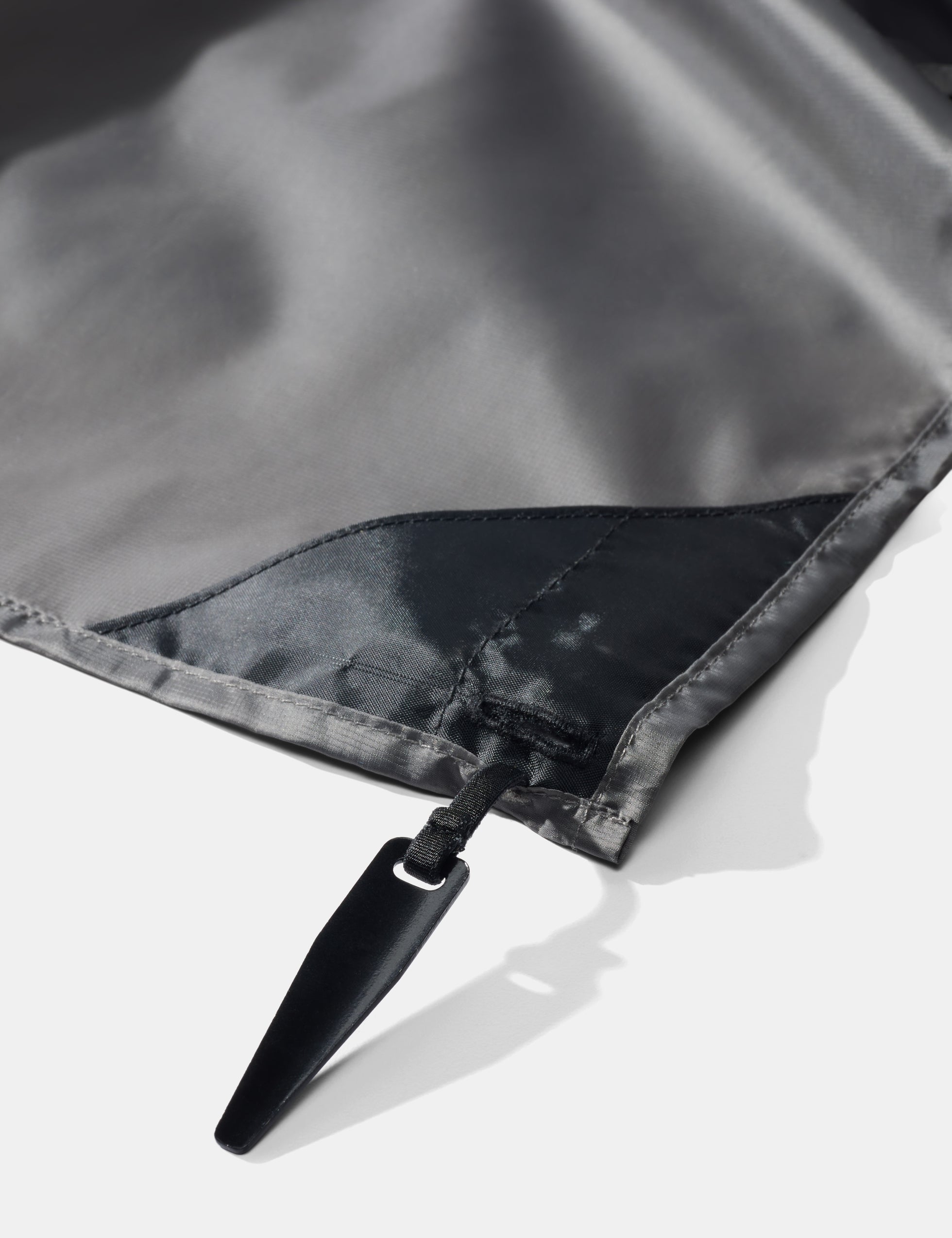 Close-up of pocket blanket corner stake on a white background