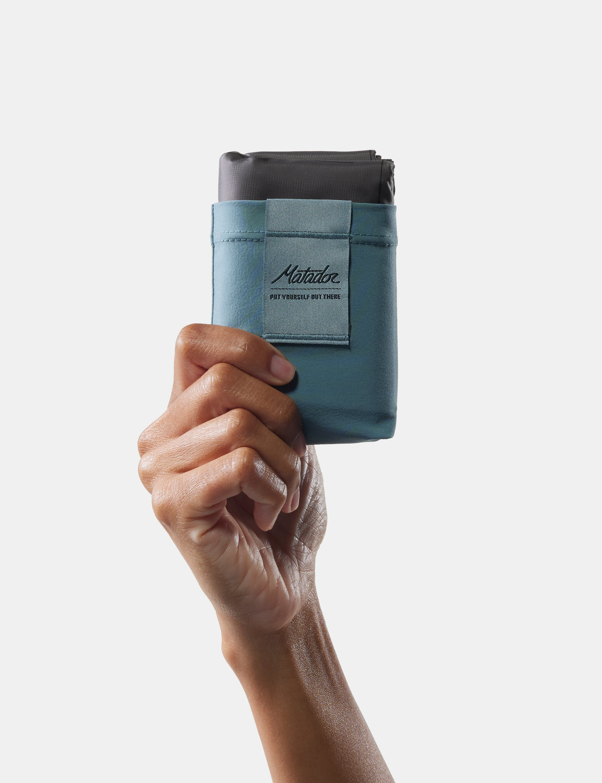 hand holding blue pocket blanket