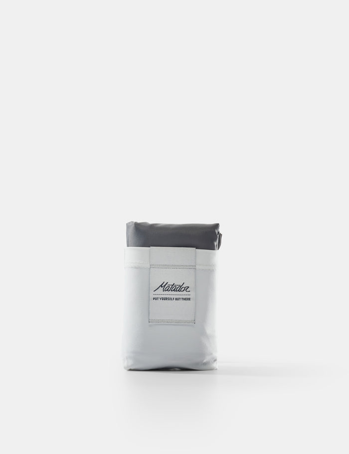Gray and white pouch with a brand label on a white background