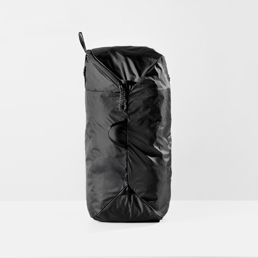 Side view of fully packed laundry bag on white studio background