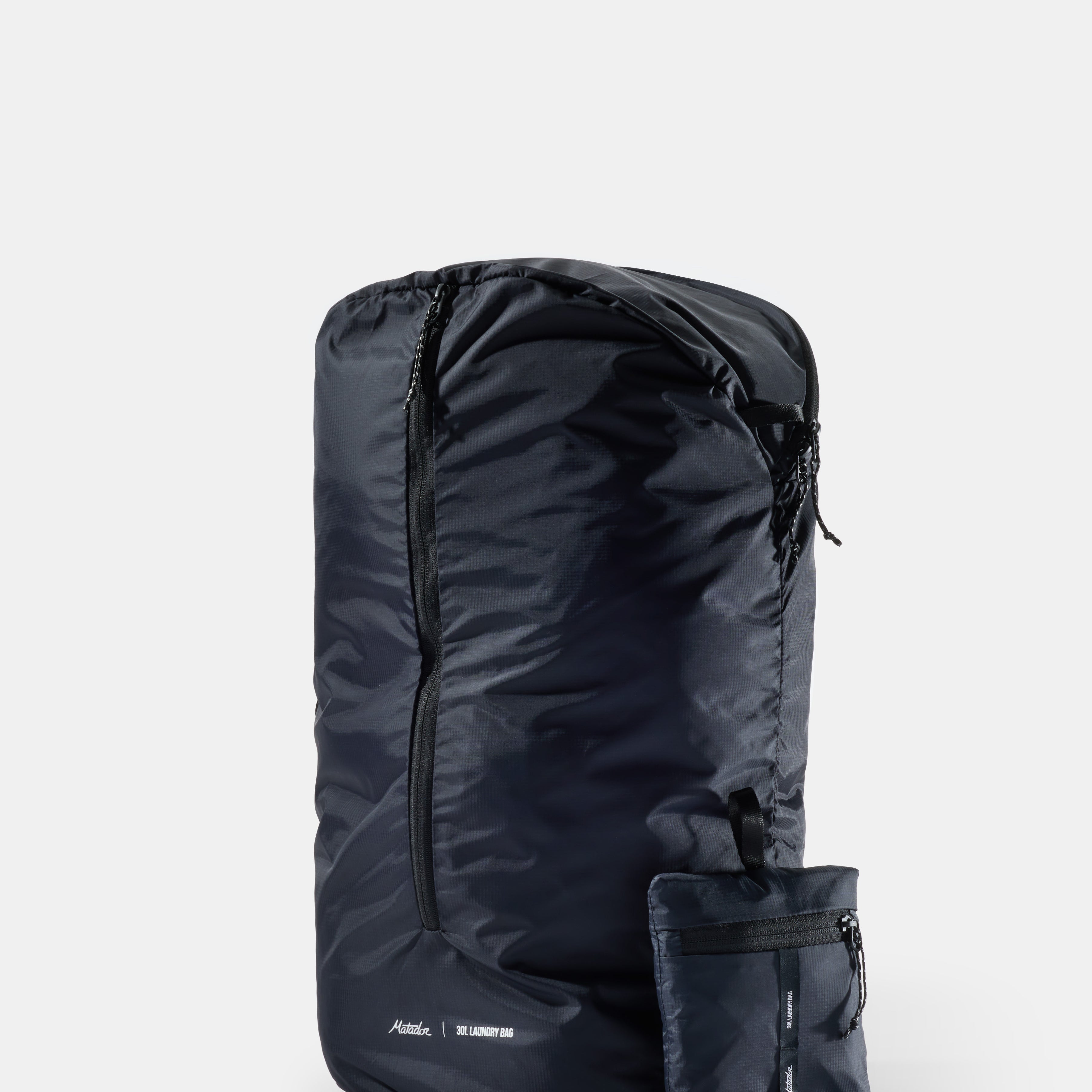 Black laundry bag with a pocket on a white background
