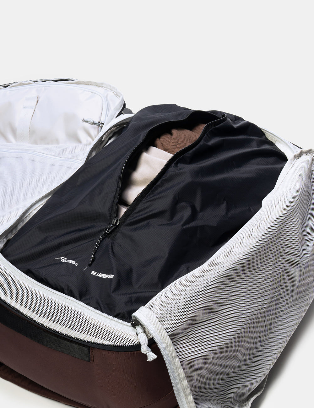 laundry bag with dirty clothing sitting in clamshell opening of bag