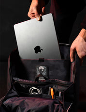 placing laptop into black backpack