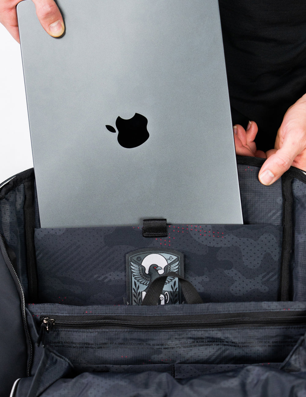 placing laptop into backpack