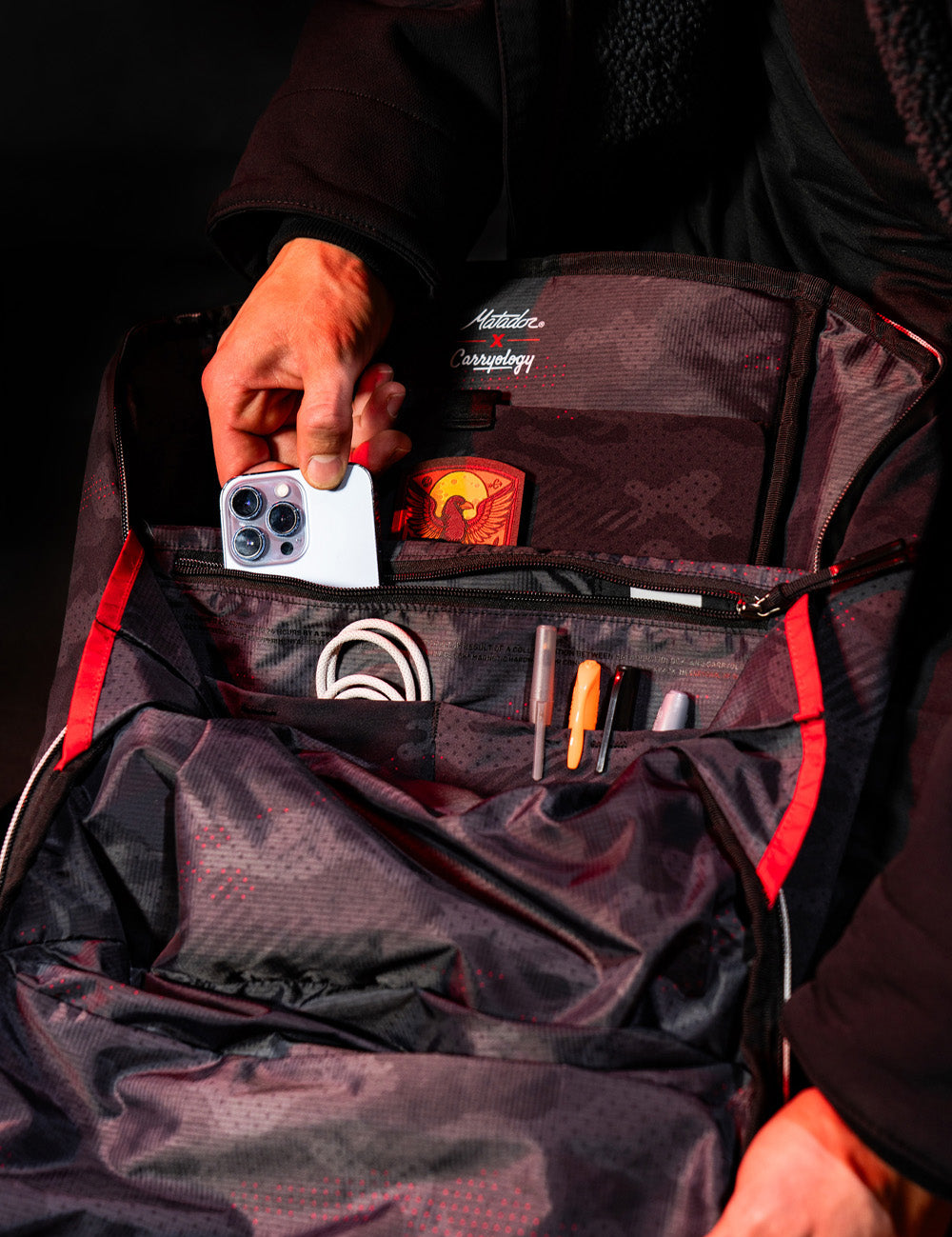 placing phone into backpack pockets
