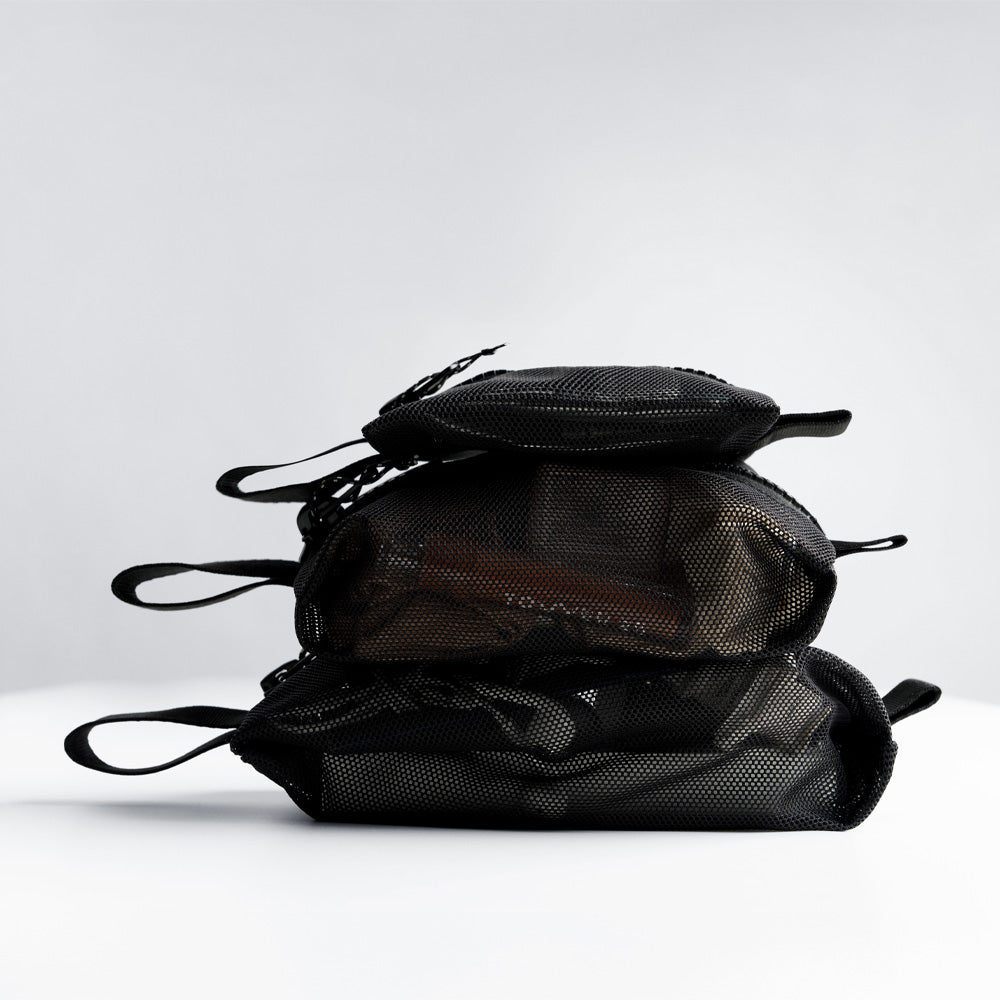 all 3 mesh bag sizes filled and stacked on top of each other on white studio background