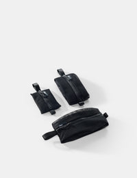 Three black pouches of varying sizes on a white background