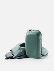green towel and silicone case on white