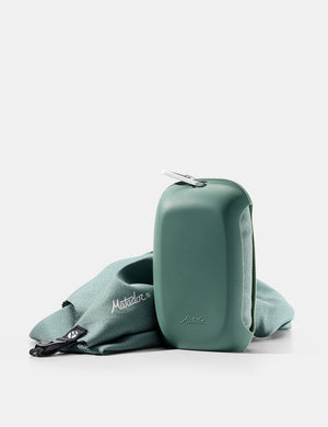 green towel and silicone case on white