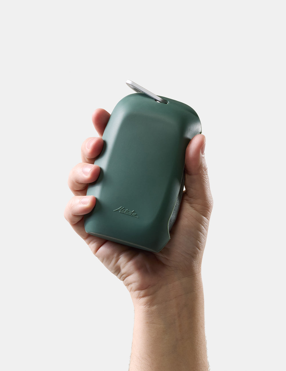 hand holding green silicone case on white