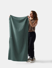 Person holding a large juniper fabric against a white background