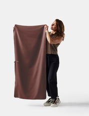 person holding garnet towel on white background