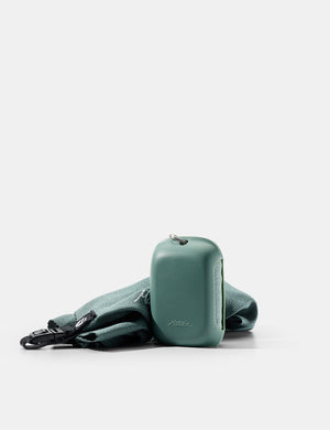 green silicone case and towel on white background