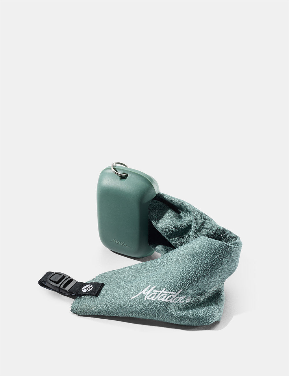 green silicone case and towel on white background