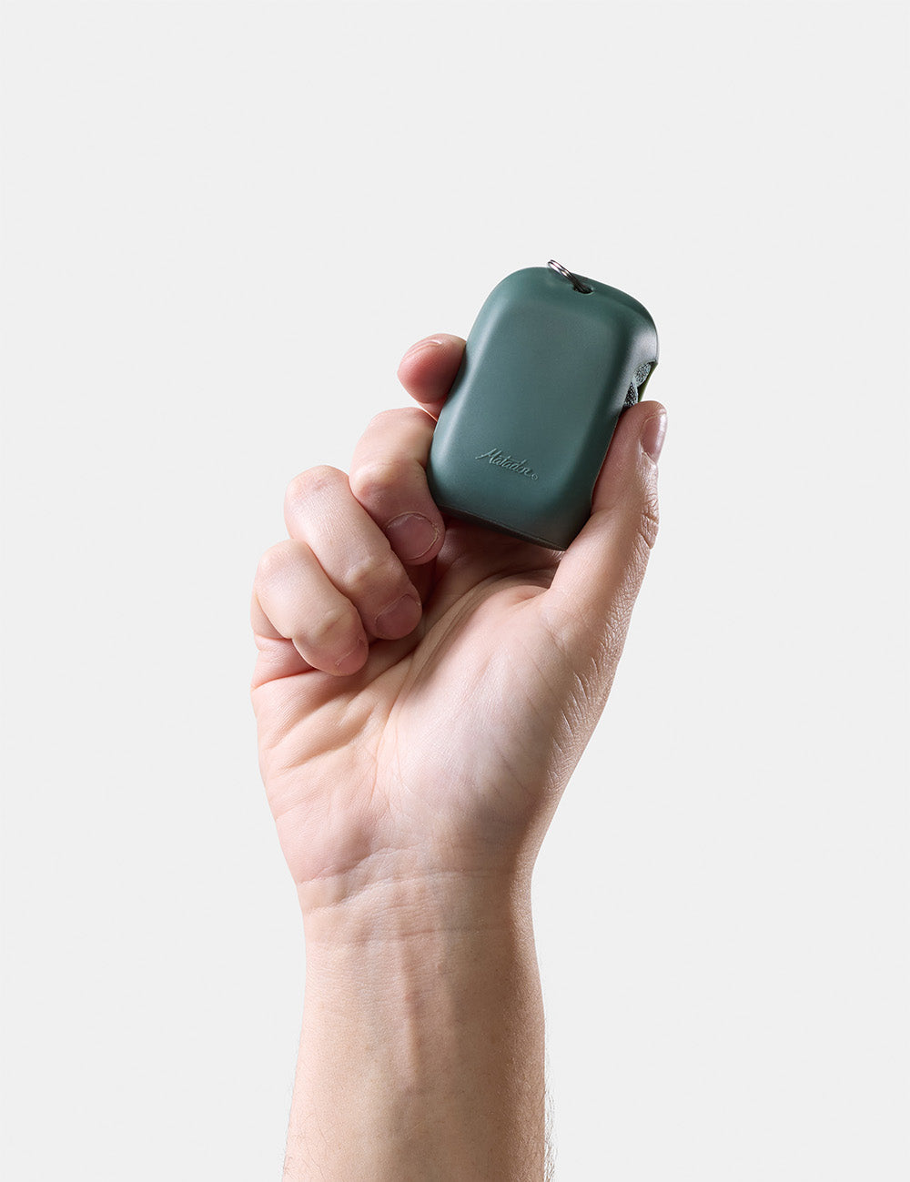 hand holding green silicone case on white background