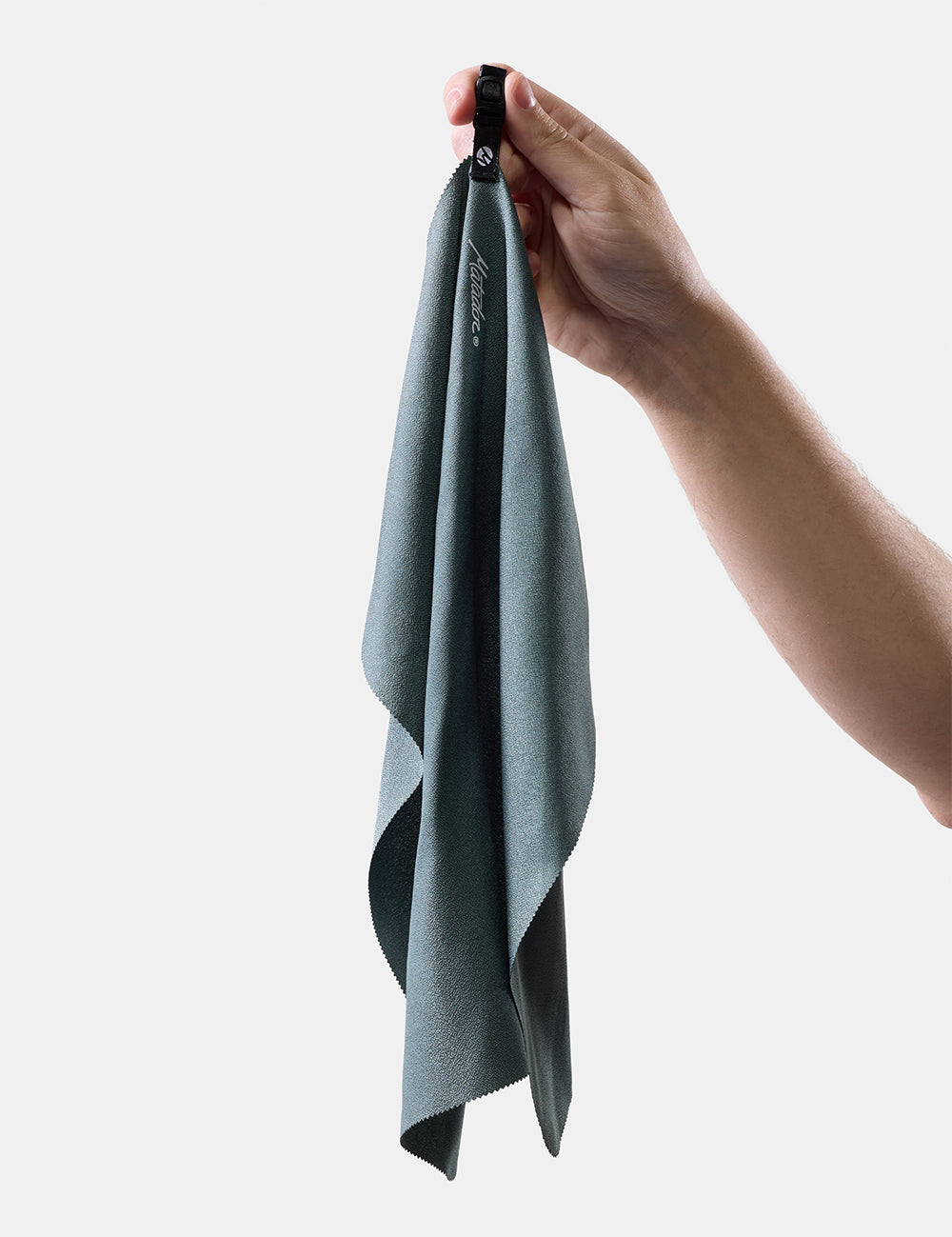hand holding light green towel on white background