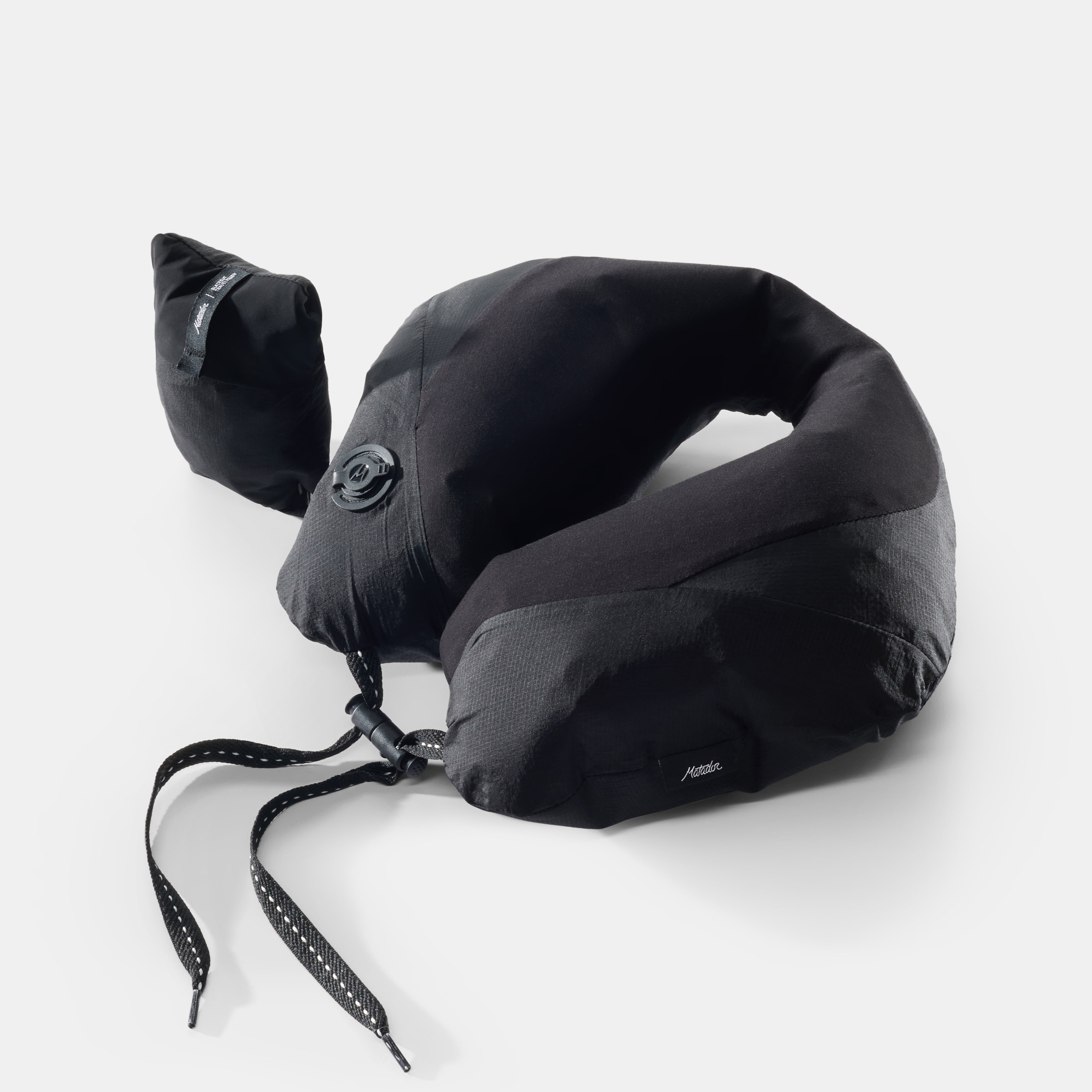 Black neck pillow on light gray background