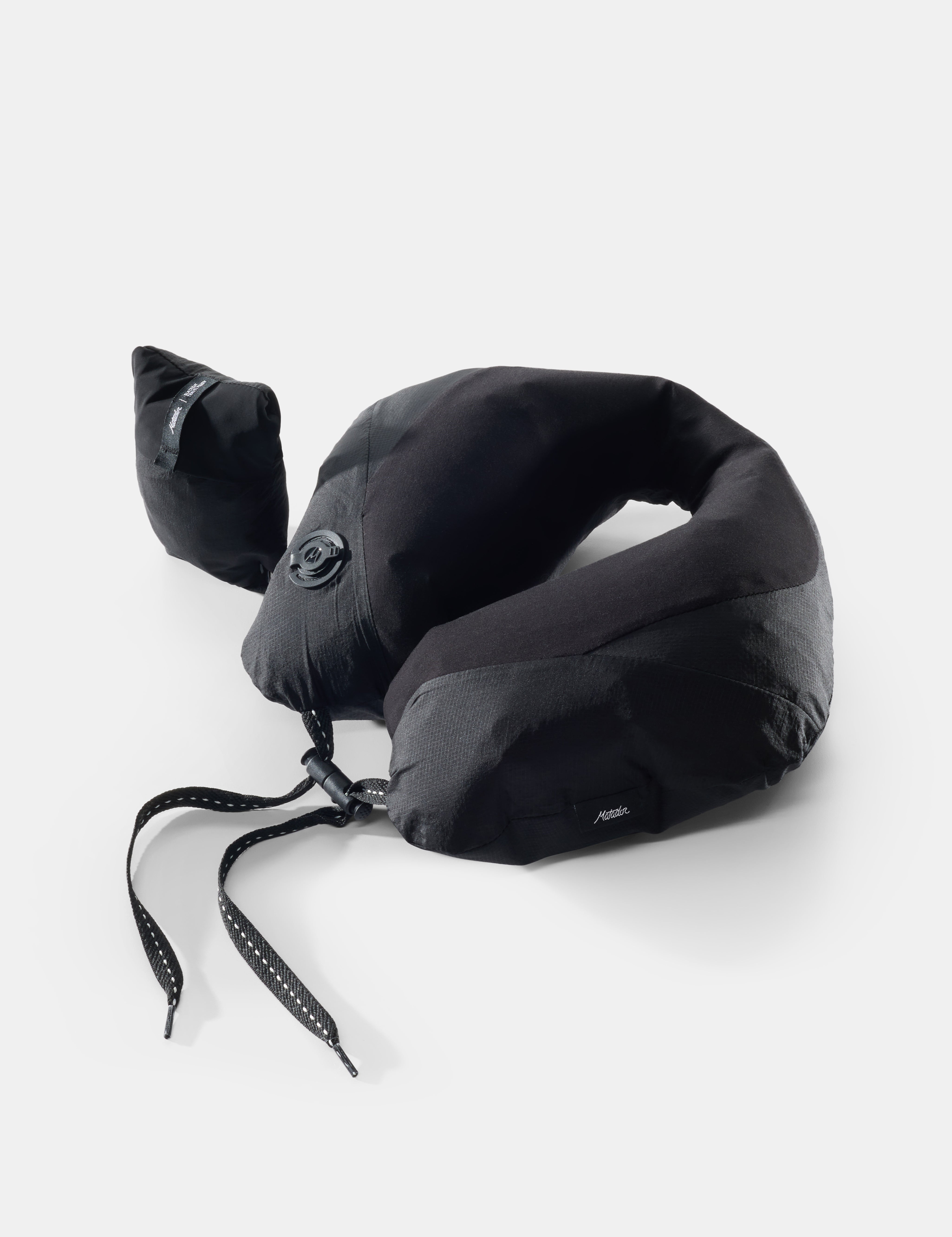 Black neck pillow on light gray background