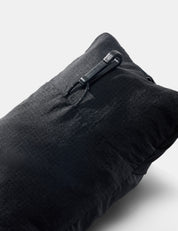 back view of packed up black neck pillow showing small hook