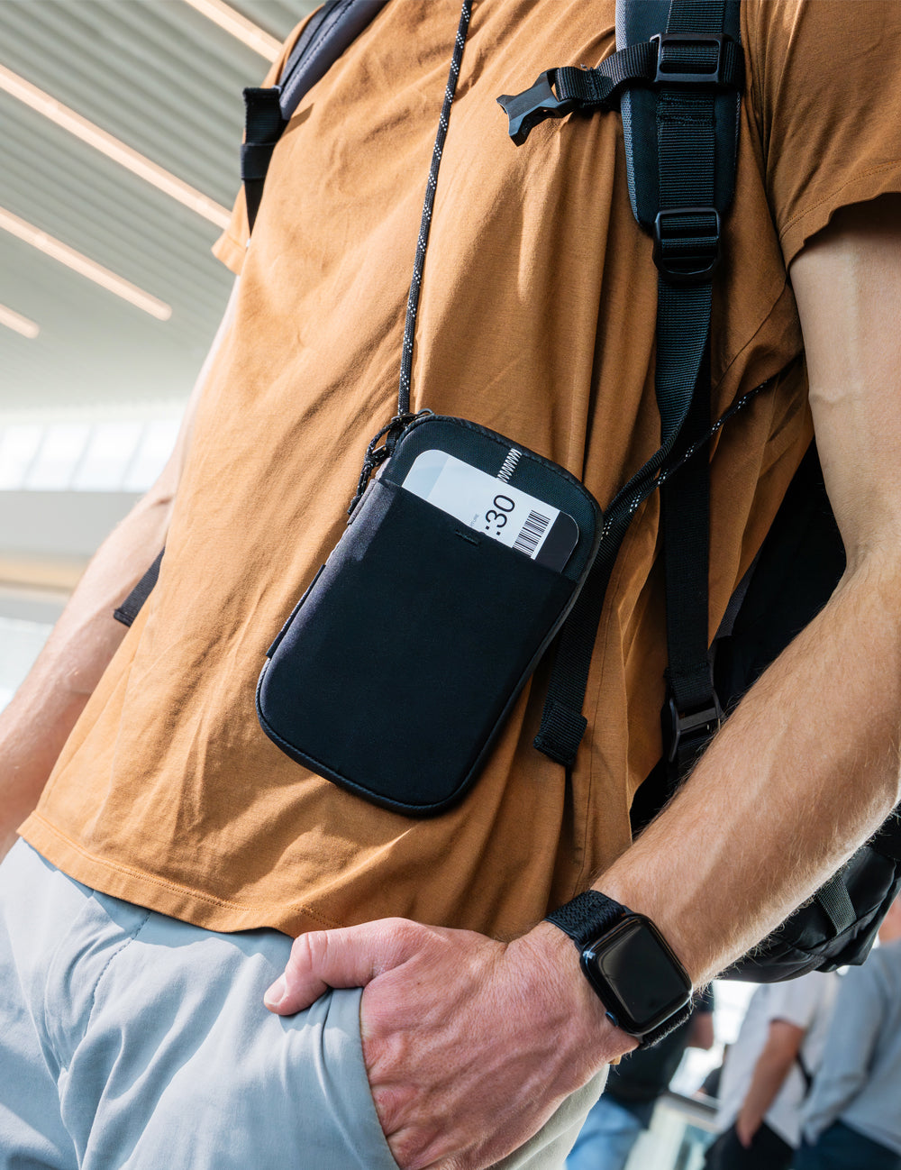 man wearing travel stash cross body