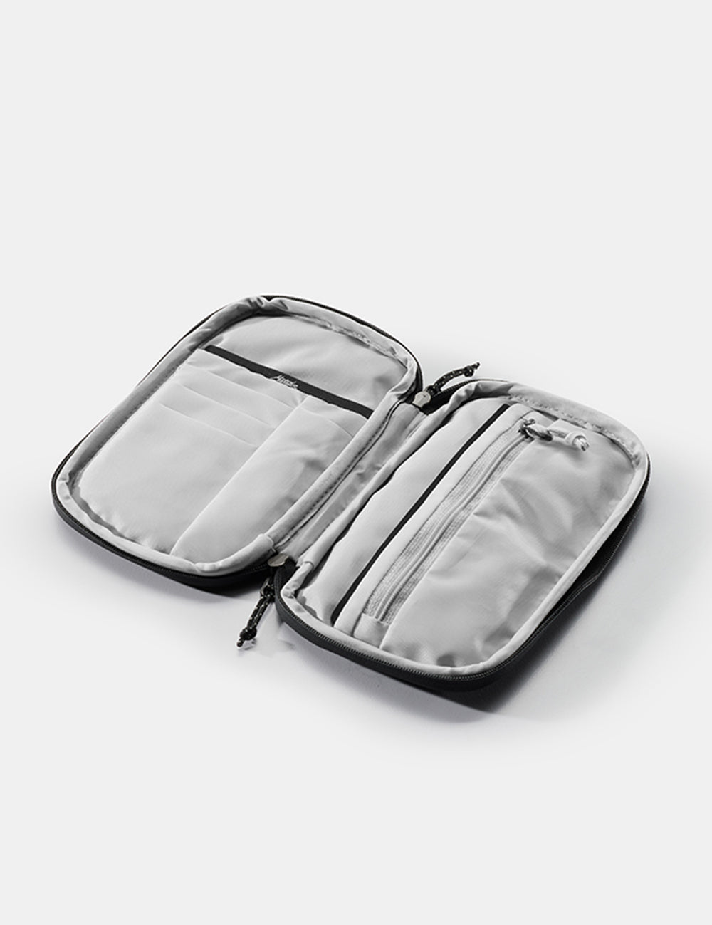 open travel wallet on white background with empty pockets and zipper
