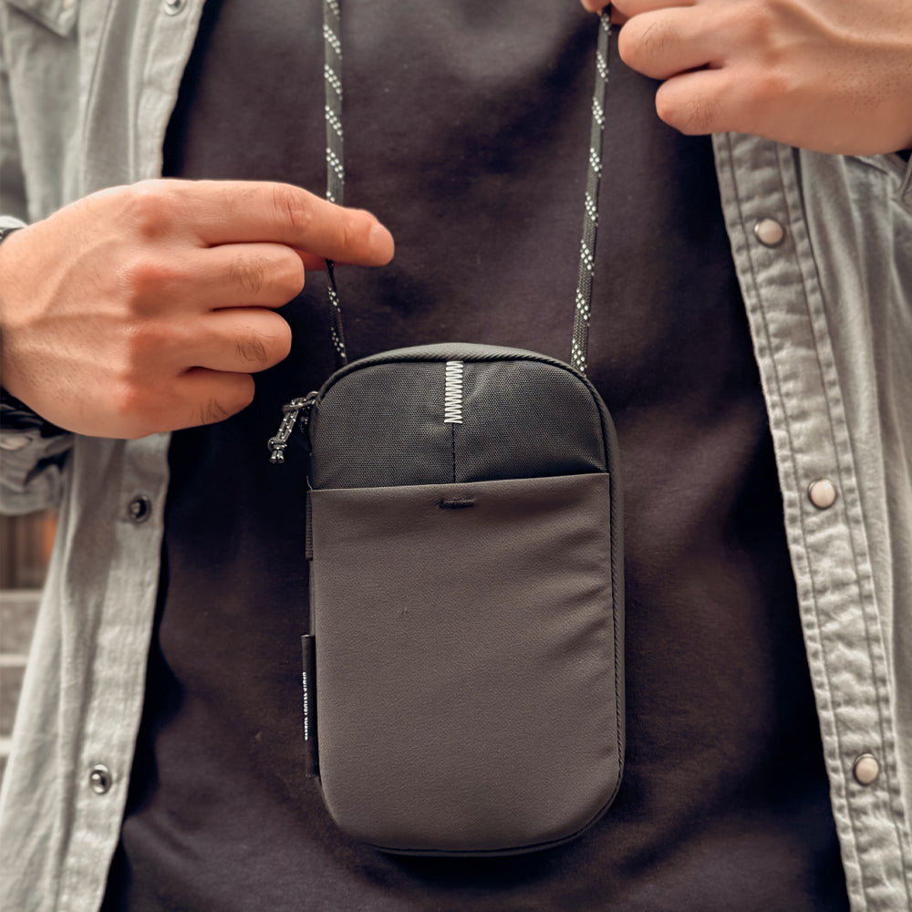 person wearing travel wallet around neck