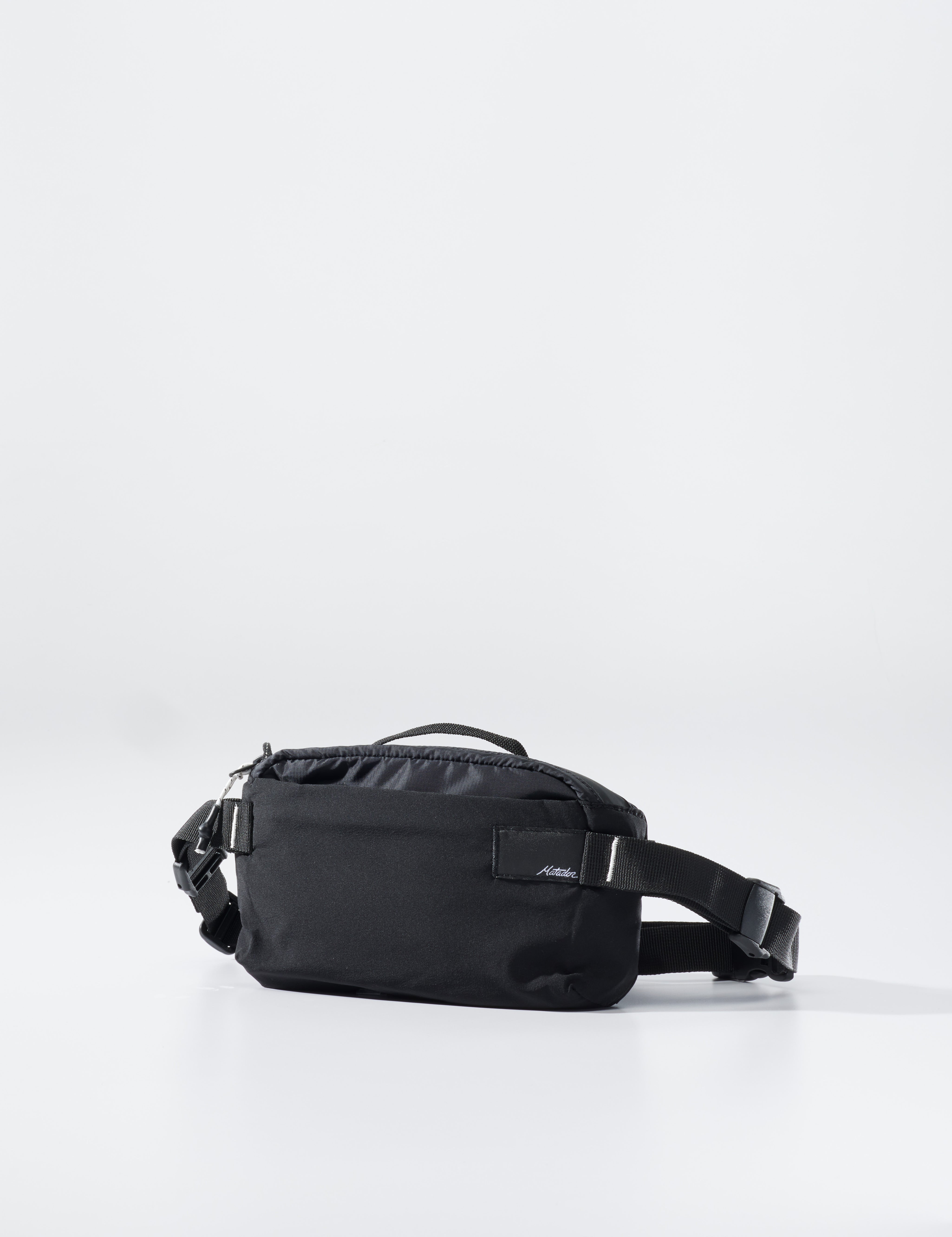 Black waist bag on a light gray background