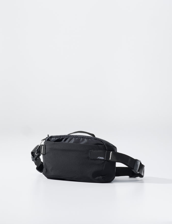 Black waist bag on a light gray background