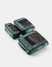 Set of green packing cubes on a white background