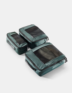 Set of green packing cubes on a white background