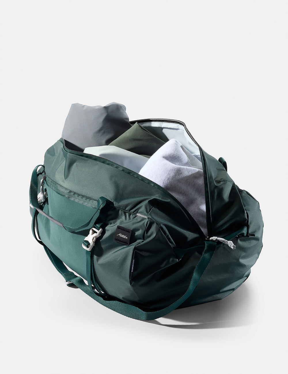 Green duffel bag on a light gray background