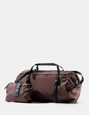 garnet duffel bag with a smaller pouch on a white background