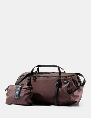 garnet duffel bag with a smaller pouch on a white background