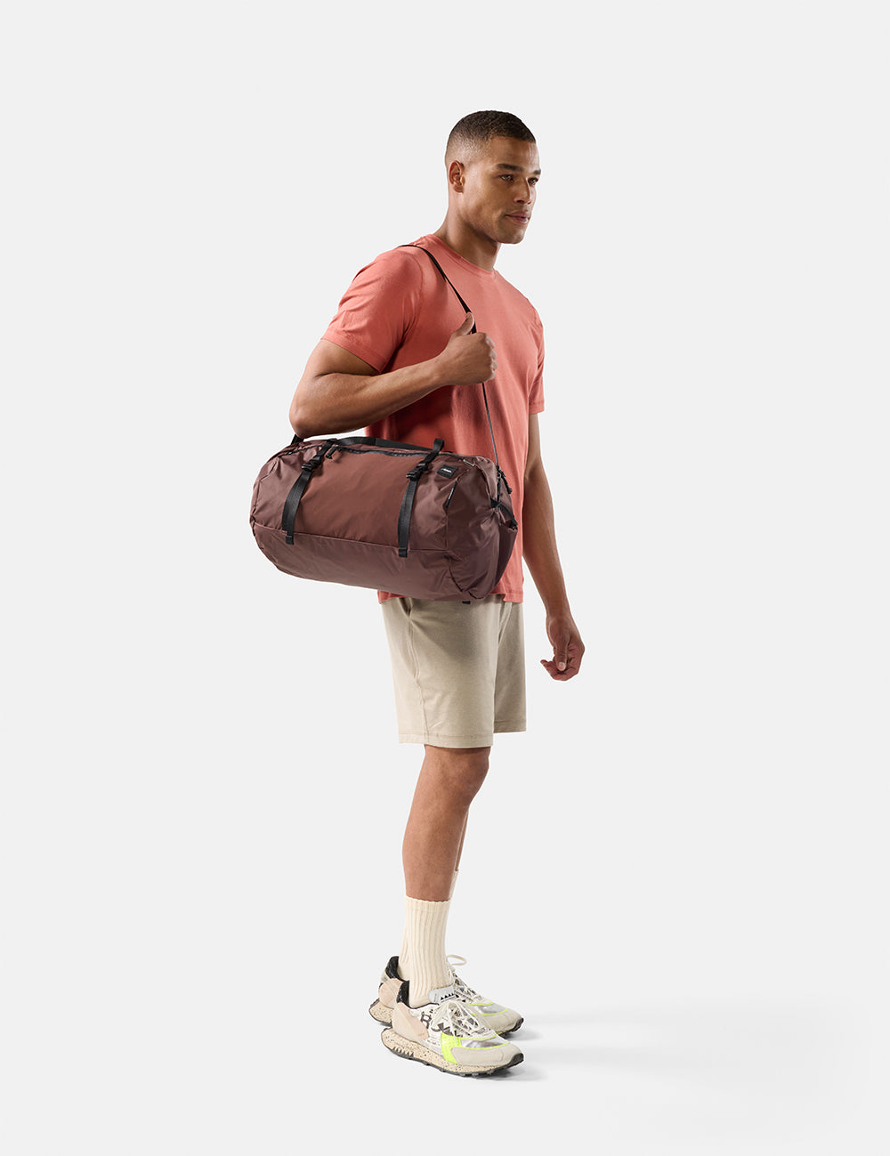 Man holding a duffel bag on a white background